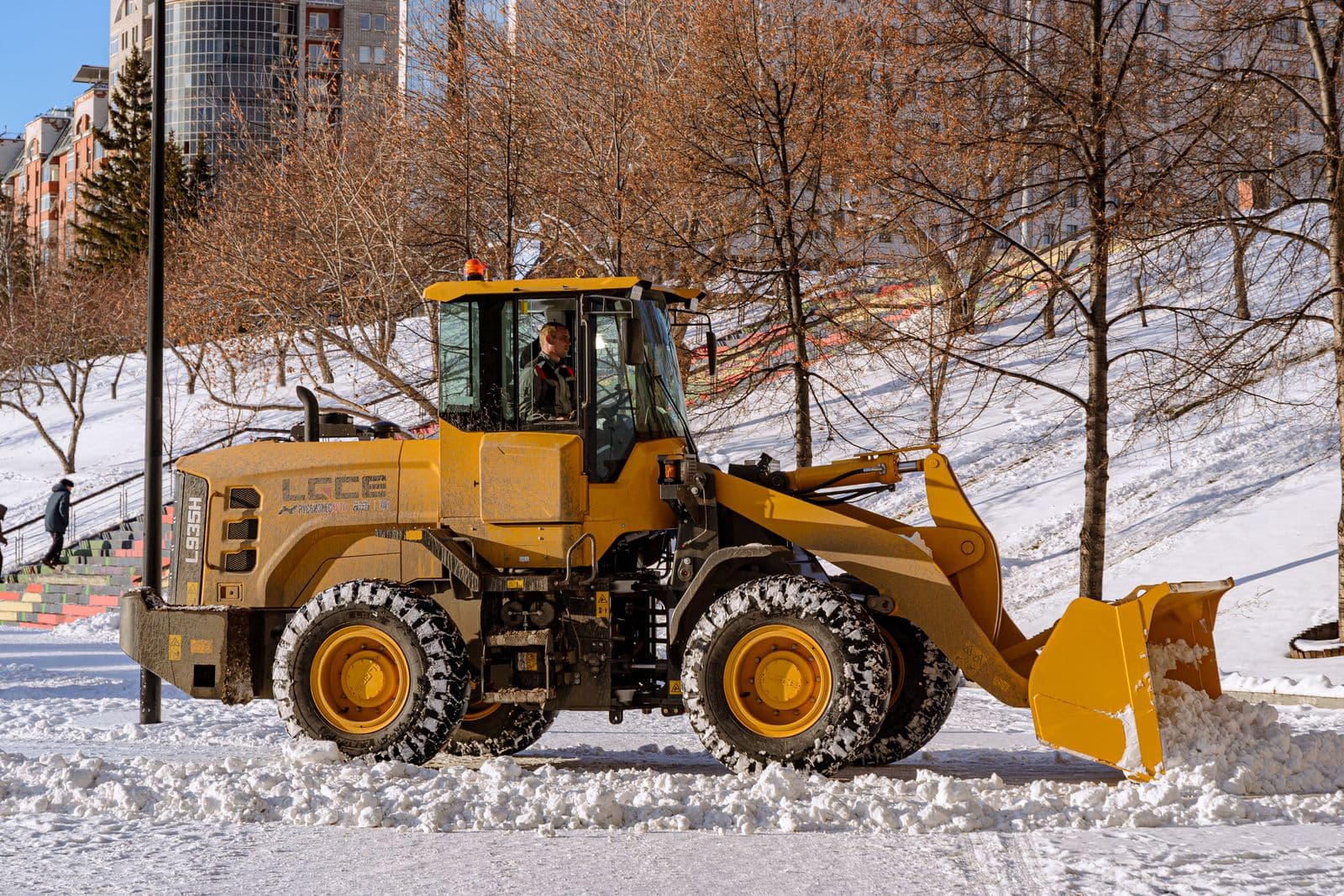 Stuart Thomas Construction — commercial snow removal in South Georgian Bay — Stock Loader Pushing Snow
