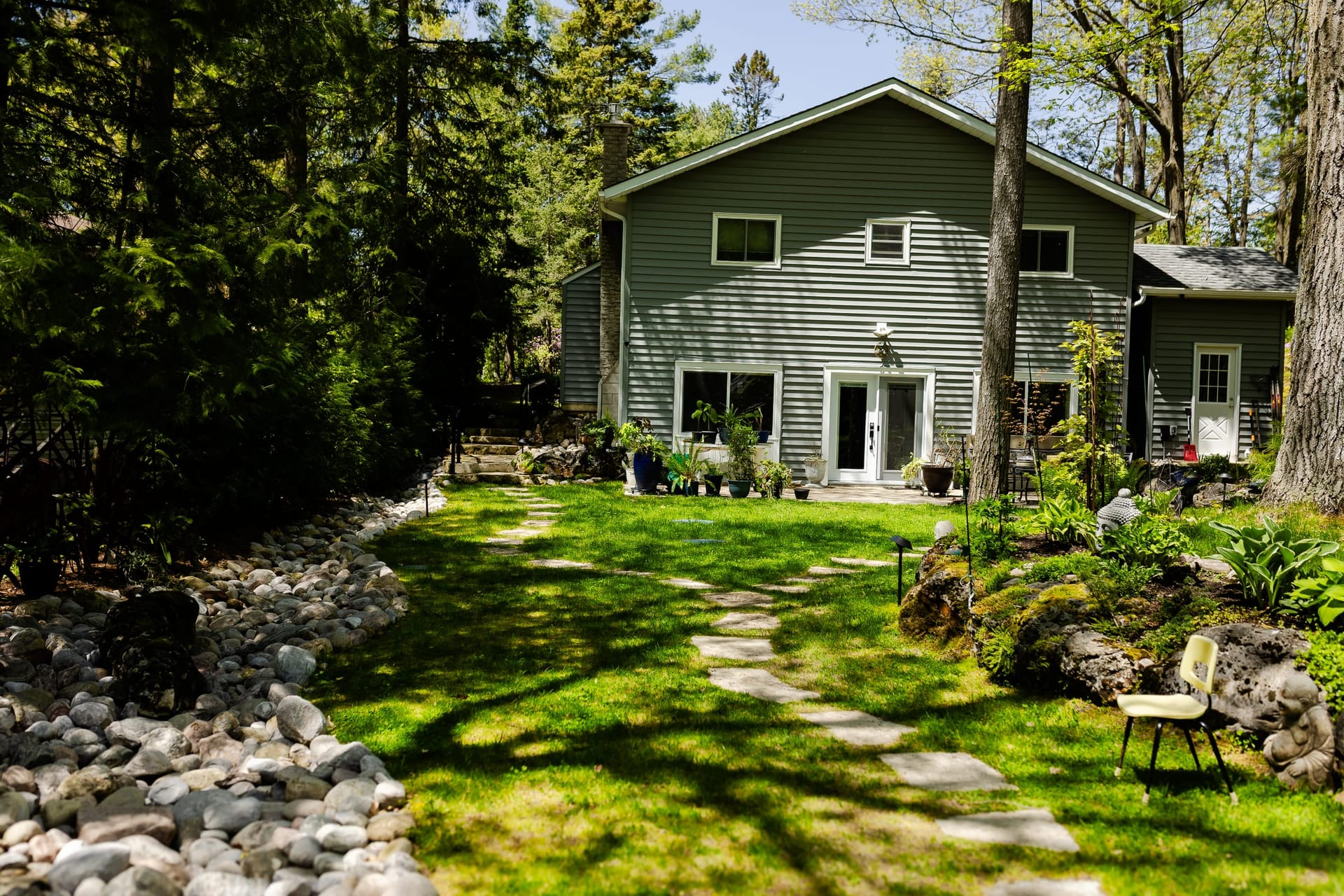 Landscaped property with stone and plantings